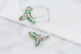 Hammered stering silver hoop earrings with clusters of shimmering faceted bright green onyx, lime green peridot and iridescent labradorite and a central wire wrapped faceted marquise labradorite with amazing flash.t